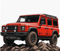 Red off-road vehicle on rocky terrain with a white background